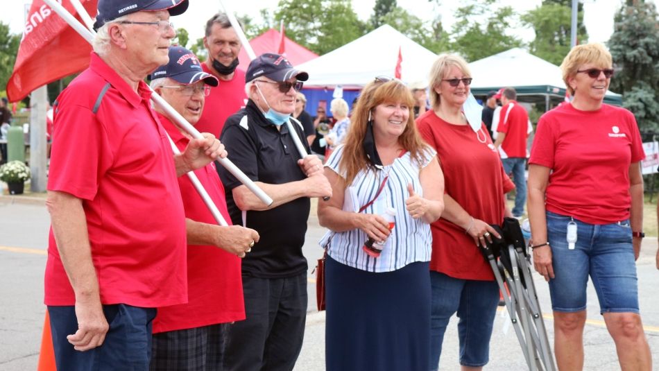 Local 673 President Maryellen McIlmoyle meets with retirees during a rally at the De Havilland plant